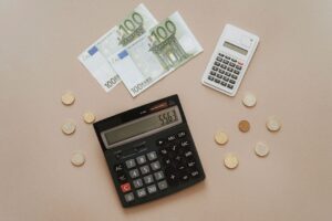 Flat lay of calculators and Euro currency, depicting financial calculations and budget management.